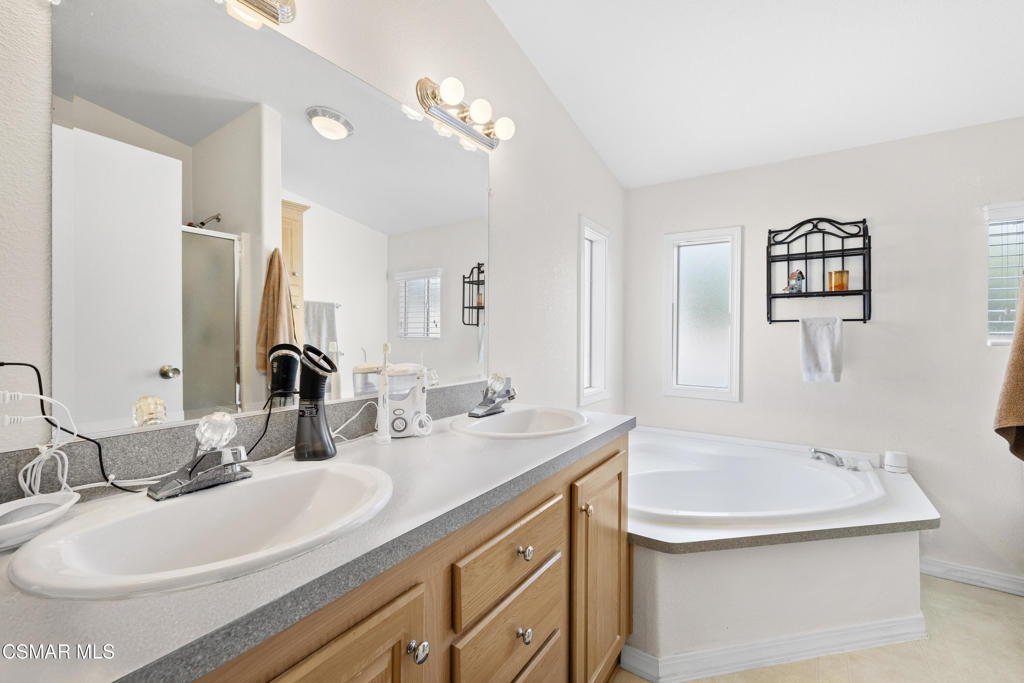 195 Tierra Rejada Road, Unit 52 Simi Valley, CA 93065 - Photo 16 of 34 a bathroom with a sink and a mirror