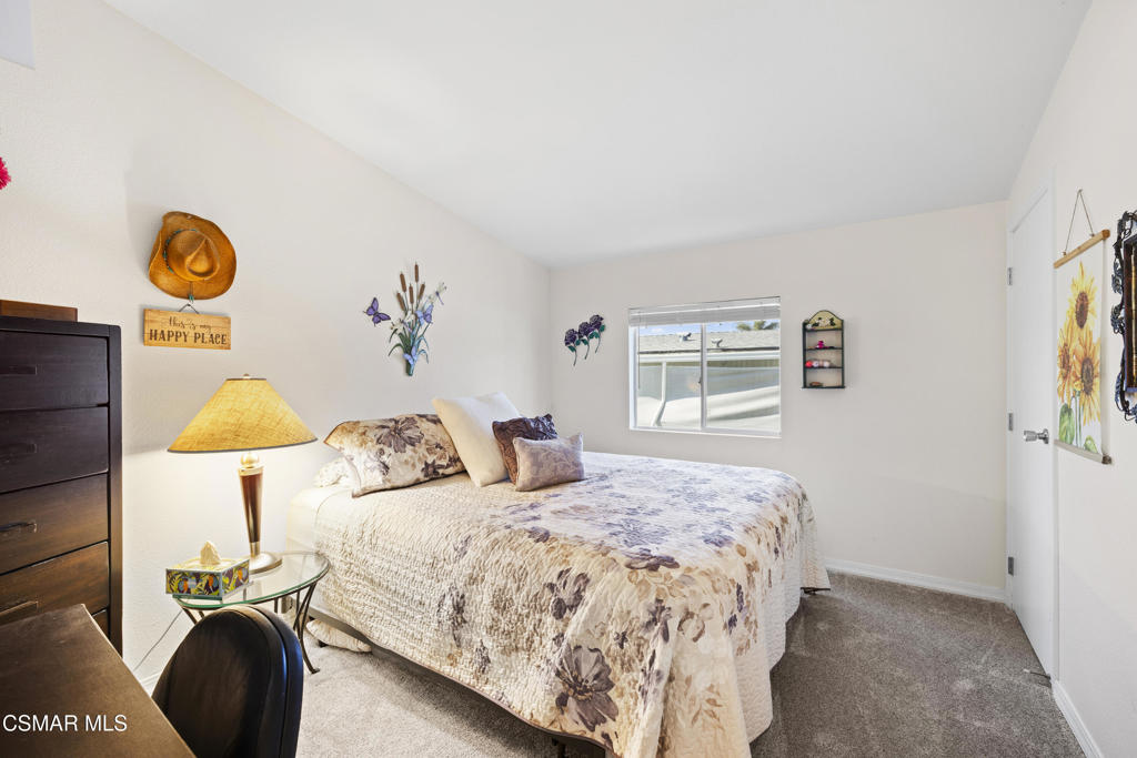 195 Tierra Rejada Road, Unit 52 Simi Valley, CA 93065 - Photo 18 of 34 a bedroom with a bed and painting on the wall