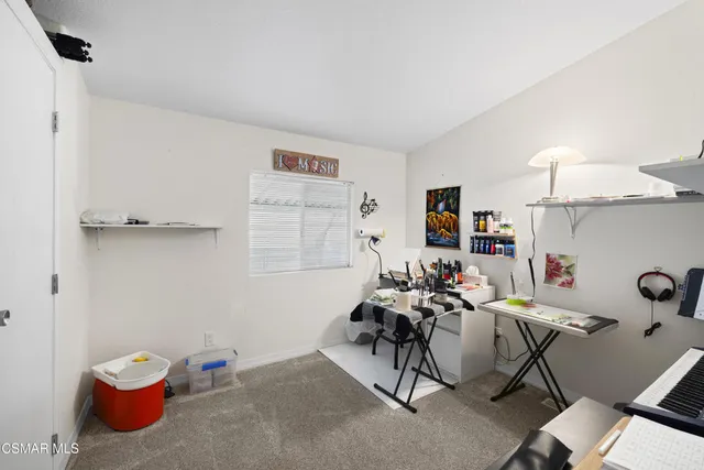 a living room with furniture and a chair