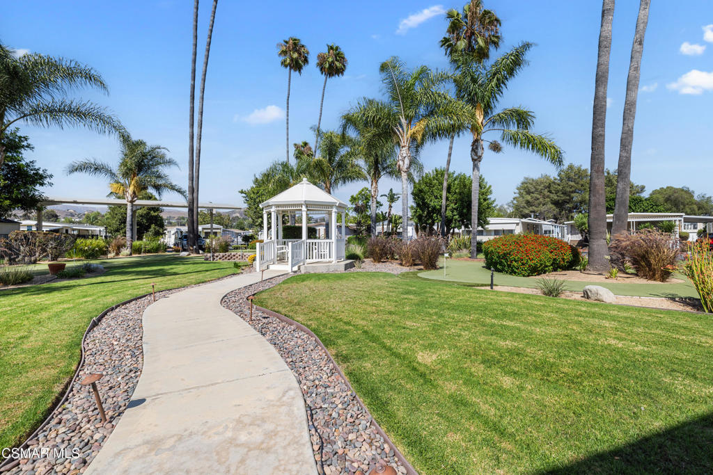 195 Tierra Rejada Road, Unit 52 Simi Valley, CA 93065 - Photo 27 of 34 a front view of a house with a yard table and chairs