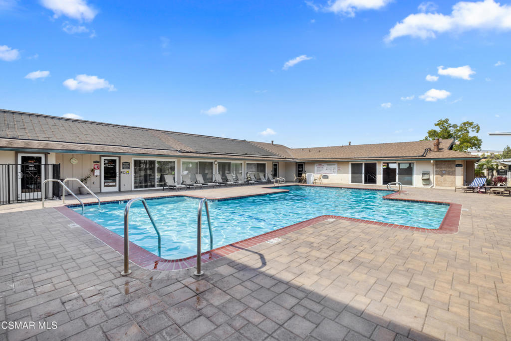 195 Tierra Rejada Road, Unit 52 Simi Valley, CA 93065 - Photo 28 of 34 a front view of a house with a yard table and chairs
