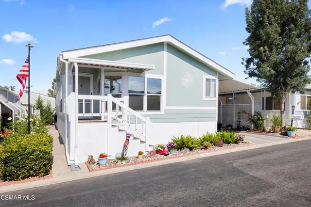 a front view of a house with potted plants
