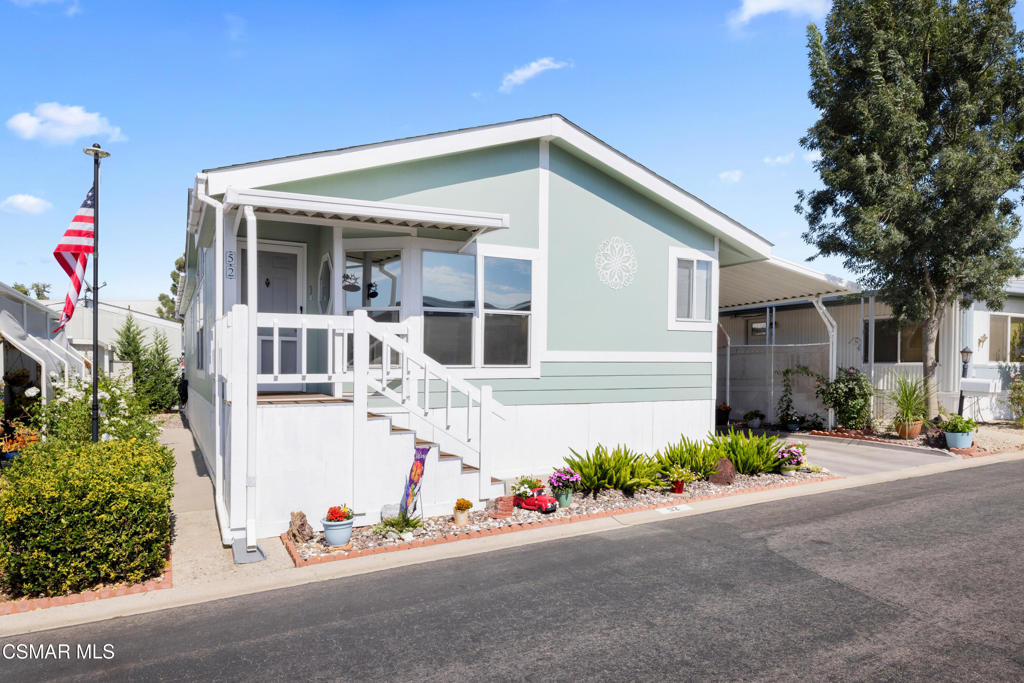 195 Tierra Rejada Road, Unit 52 Simi Valley, CA 93065 - Photo 3 of 34 a front view of a house with potted plants