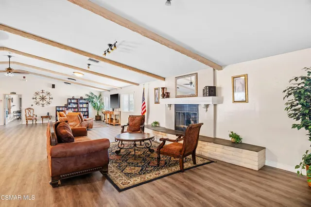 a living room with fireplace furniture and a wooden floor
