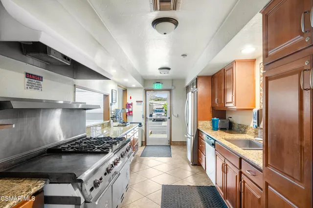 a kitchen with stainless steel appliances granite countertop a stove and a sink