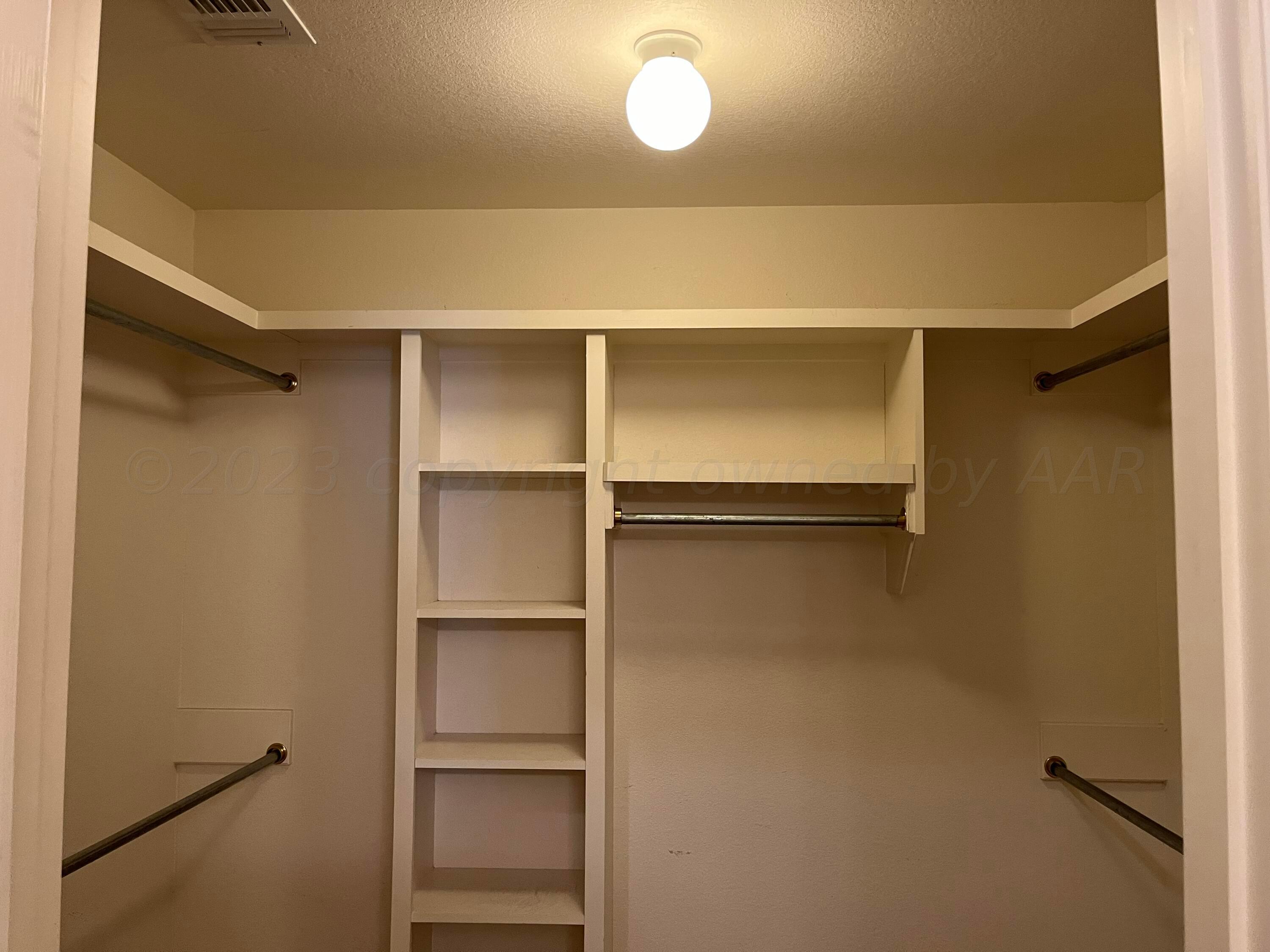 2 Windtree Amarillo, TX 79121 - Photo 12 of 15 a view of walk in closet with empty racks