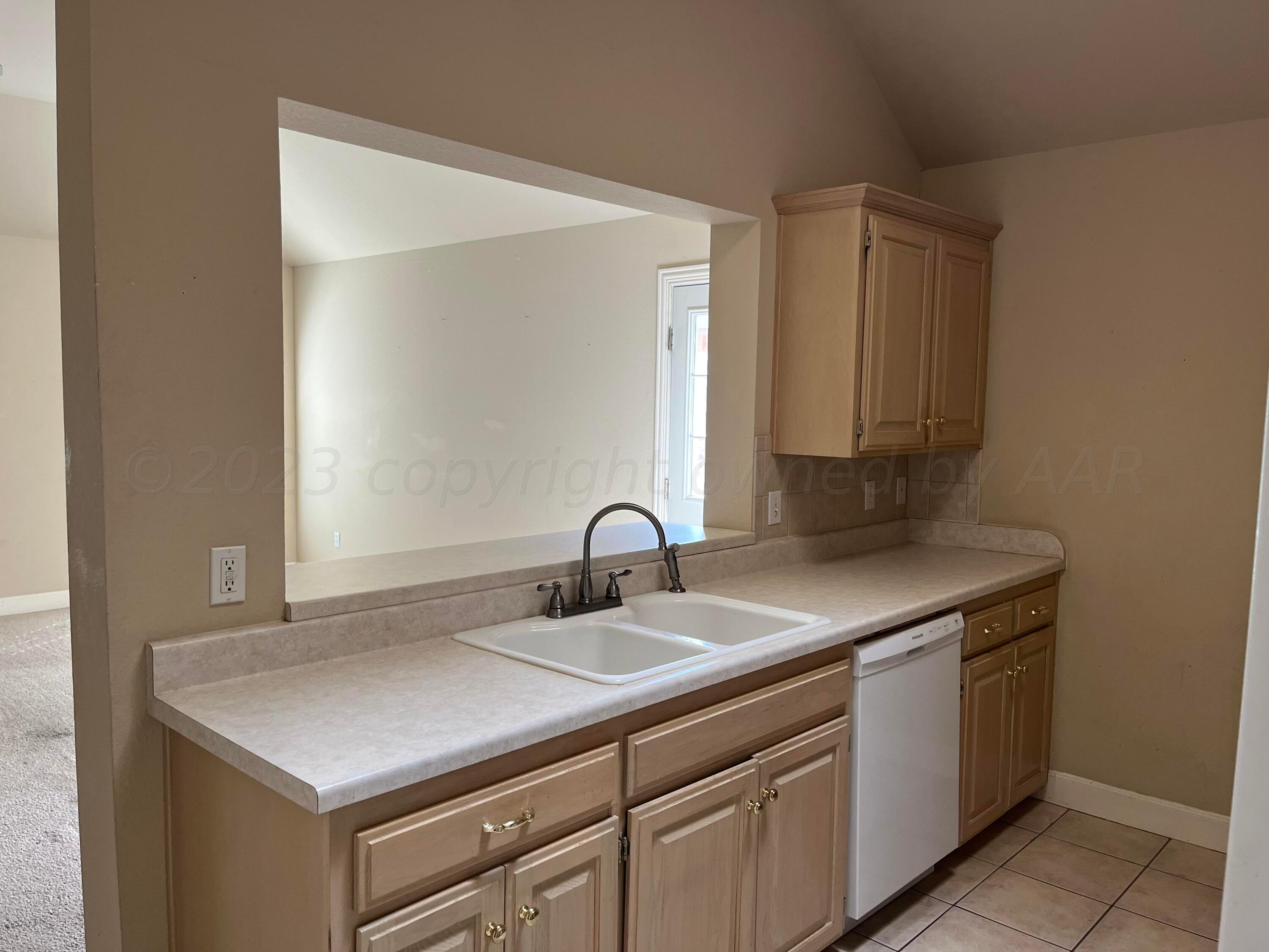 2 Windtree Amarillo, TX 79121 - Photo 5 of 15 a kitchen with a sink cabinets and a window