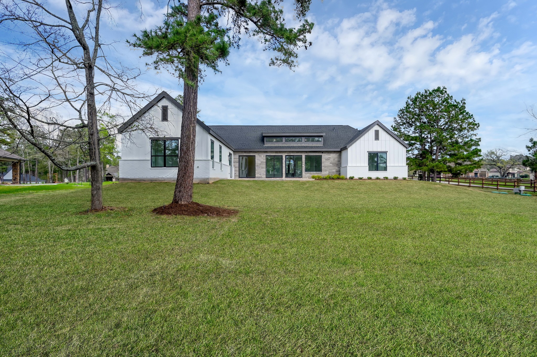 14742 Turquoise Trail Willis, TX 77378 - Photo 39 of 48 Expansive backyard view highlighting the home’s impressive architecture and the generous 1+ acre lot.