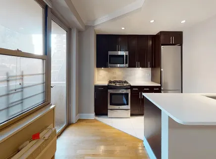 a kitchen with stainless steel appliances a stove a microwave and a refrigerator