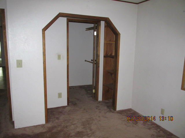 9264 Thatcher Road Shingletown, CA 96088 - Photo 11 of 13 a view of a hallway with closet and wooden floor