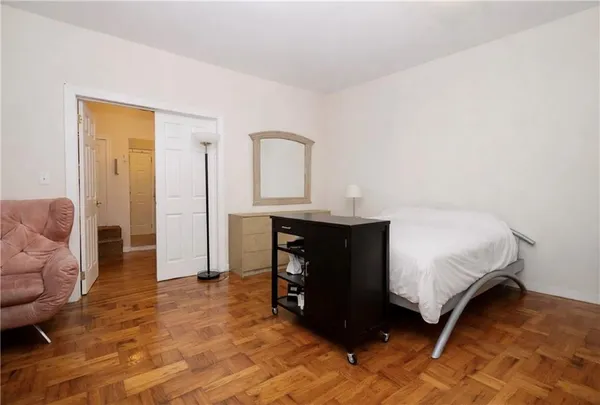 a bedroom with a bed and a couch