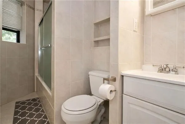 a bathroom with a toilet a sink and a shower