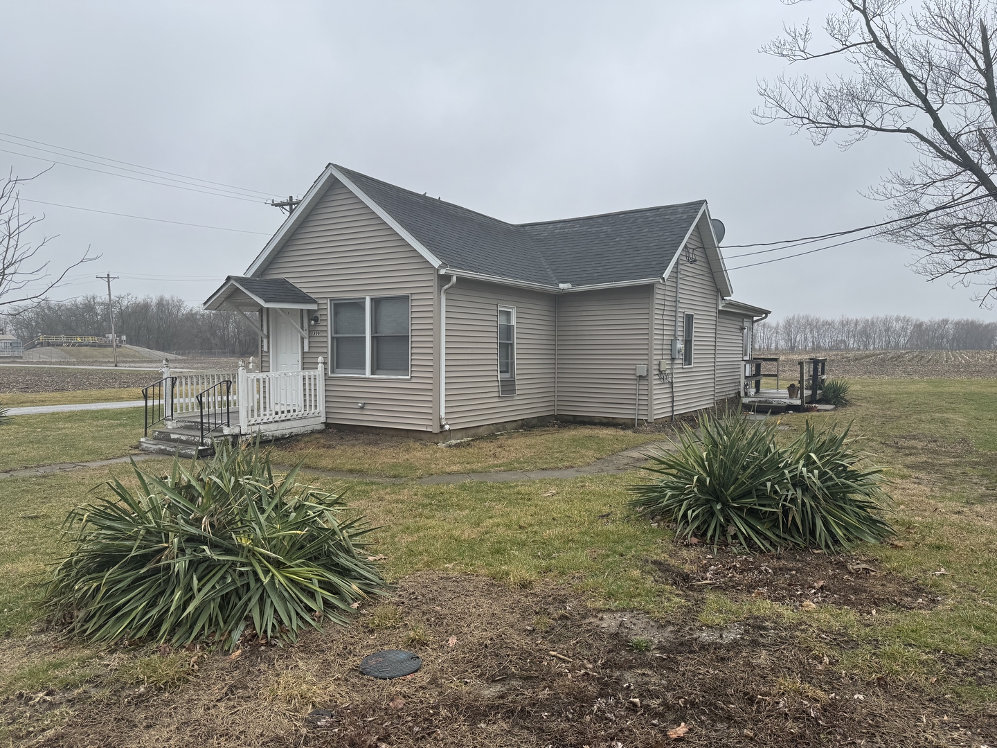 a view of a house with a yard next to a lake