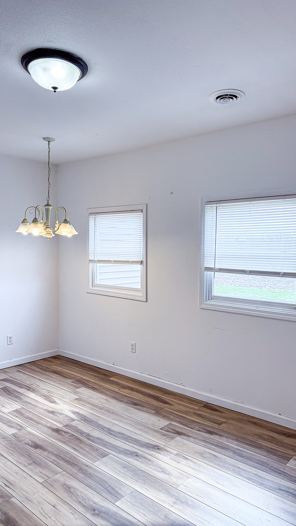 319 Missouri Street Atwood, IL 61913 - Photo 11 of 22 a view of wooden floor chandelier and window in a room