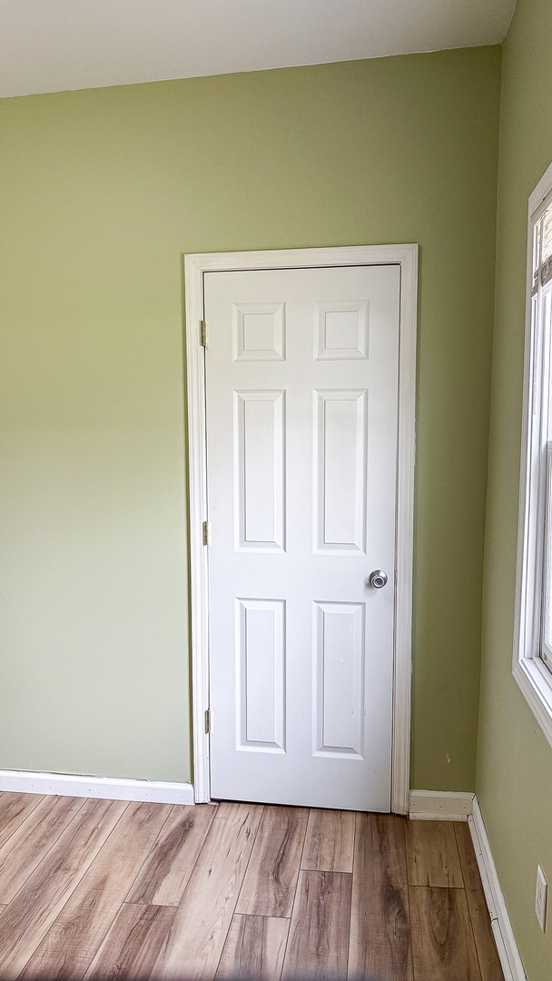 319 Missouri Street Atwood, IL 61913 - Photo 12 of 22 an empty room with wooden floor and closet area