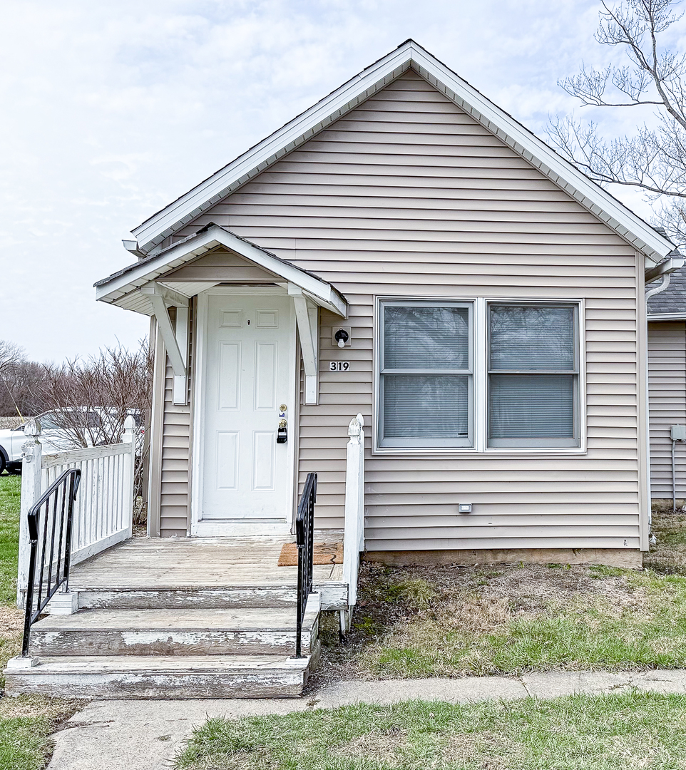 319 Missouri Street Atwood, IL 61913 - Photo 2 of 22 a front view of a house with a yard