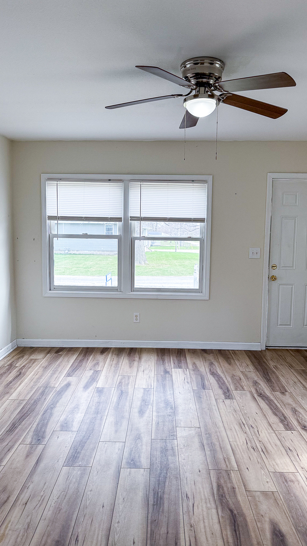 319 Missouri Street Atwood, IL 61913 - Photo 5 of 22 a view of an empty room with wooden floor and a window