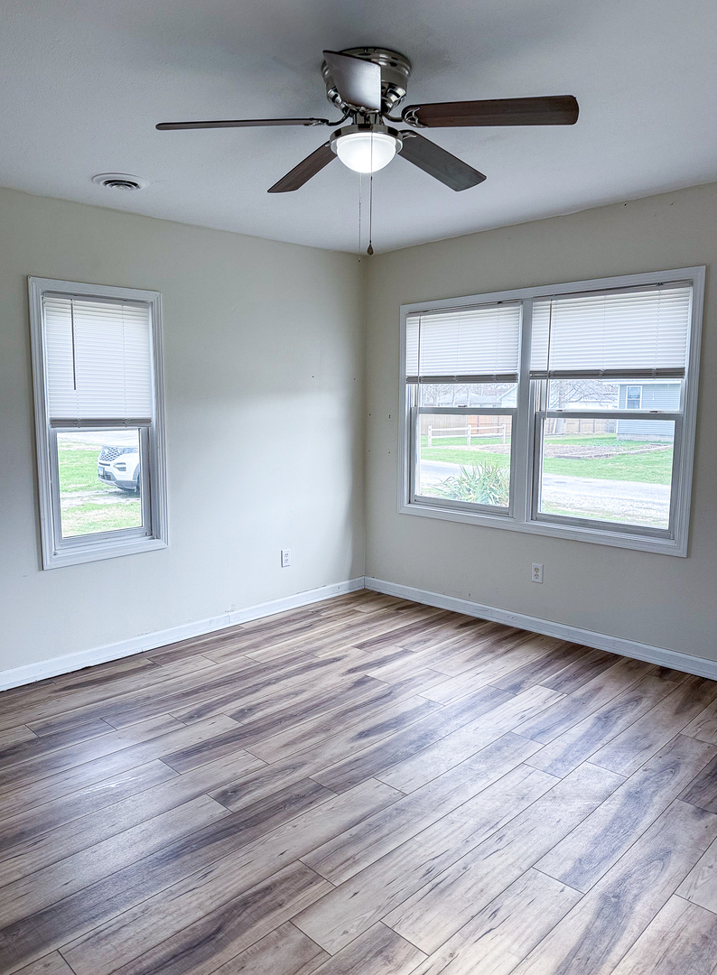 319 Missouri Street Atwood, IL 61913 - Photo 6 of 22 a view of an empty room with wooden floor and a window