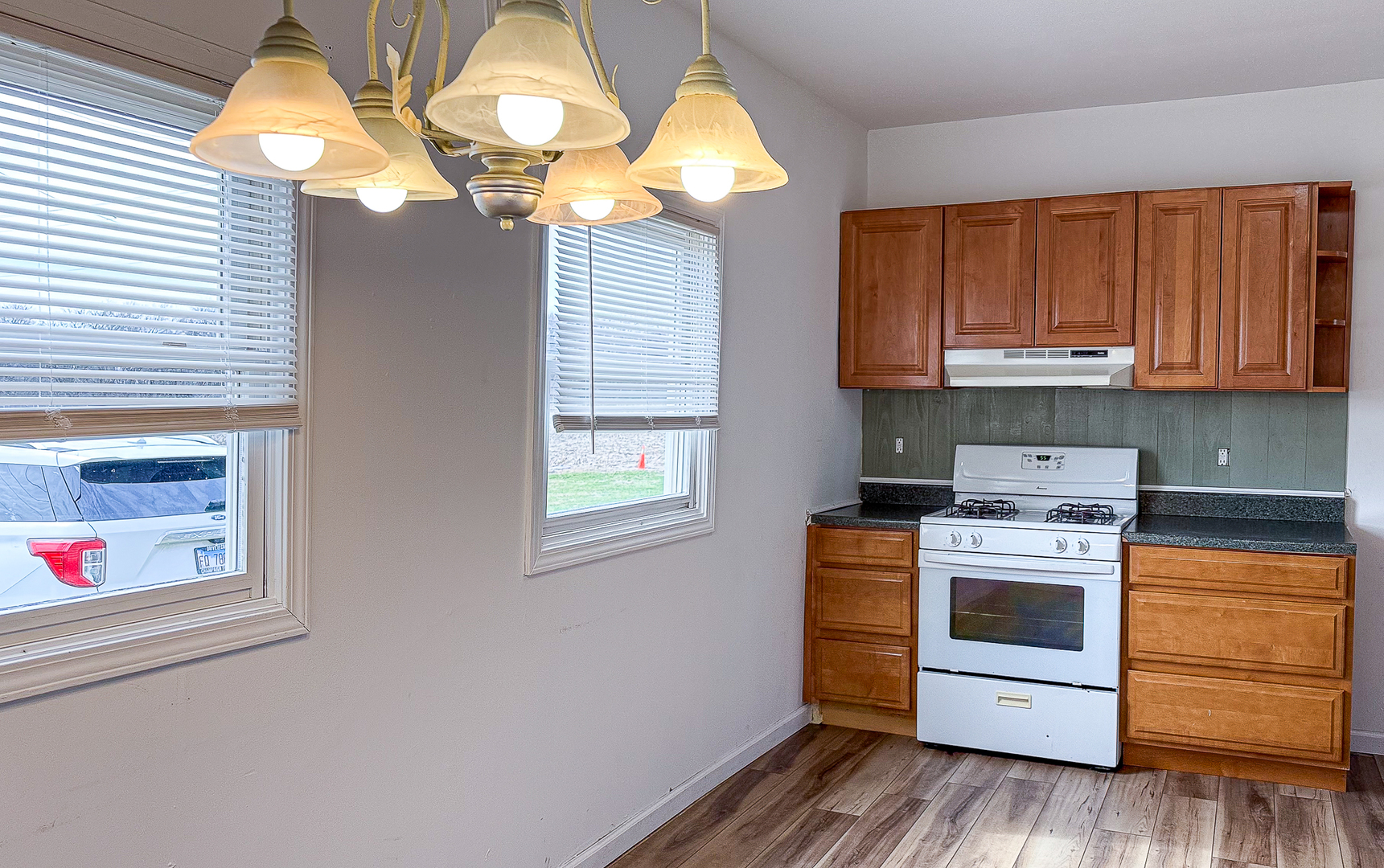 319 Missouri Street Atwood, IL 61913 - Photo 8 of 22 a kitchen with stainless steel appliances granite countertop a stove a cabinets and a chandelier