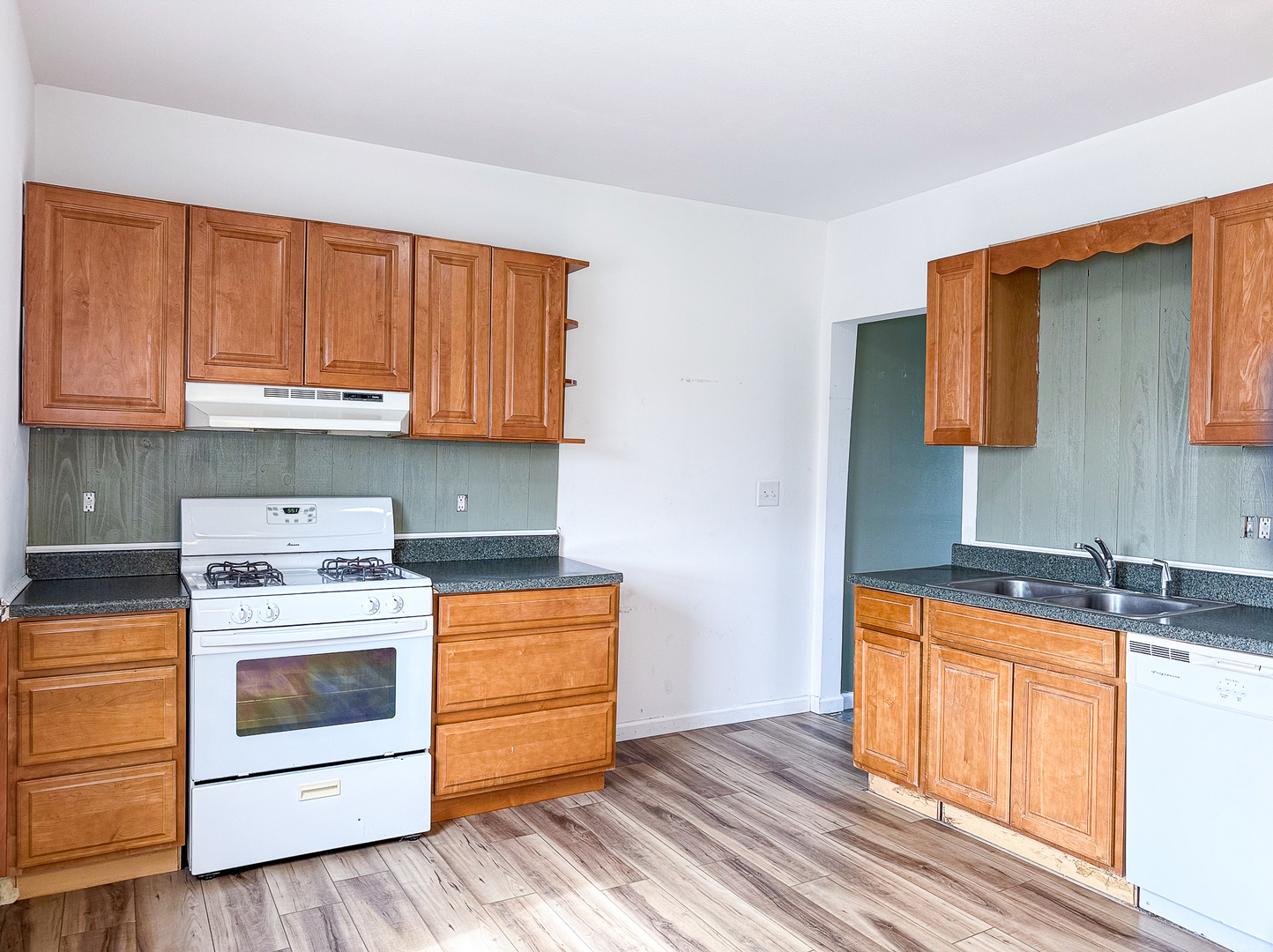319 Missouri Street Atwood, IL 61913 - Photo 10 of 22 a kitchen with stainless steel appliances granite countertop a stove a sink and a microwave