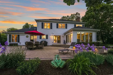 a front view of a house with yard and sitting area