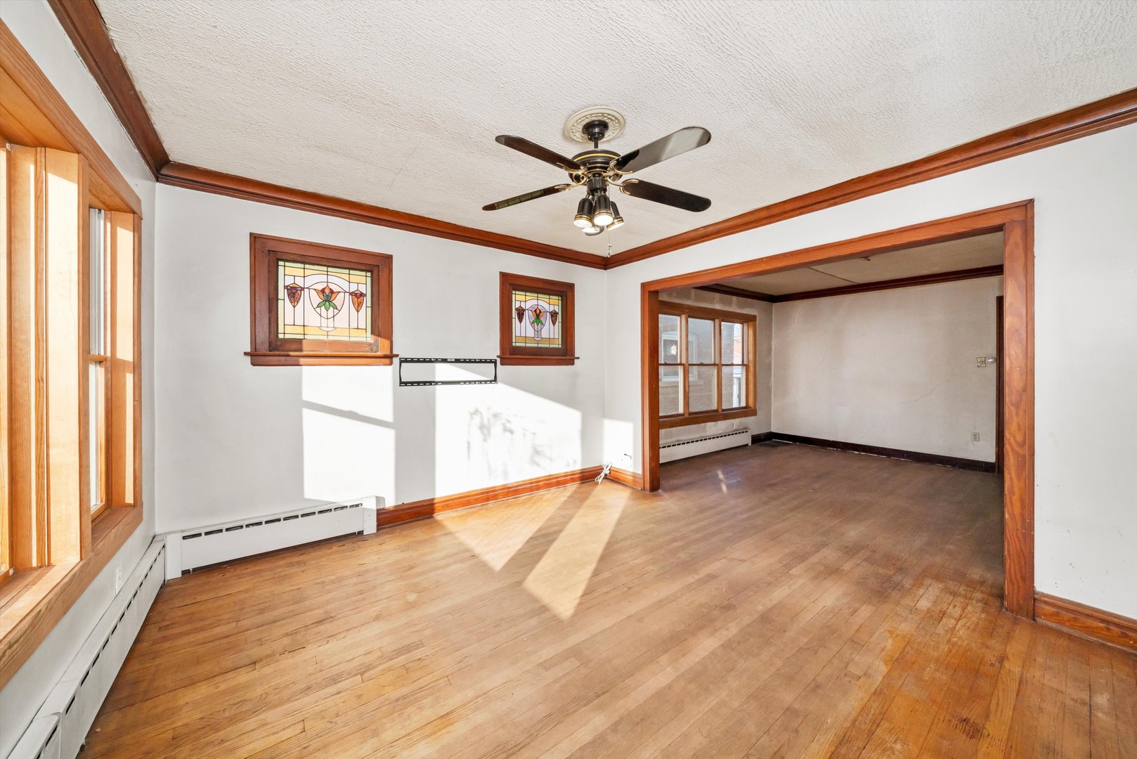 7424 57th Place Summit, IL 60501 - Photo 4 of 13 a view of empty room with wooden floor and fan