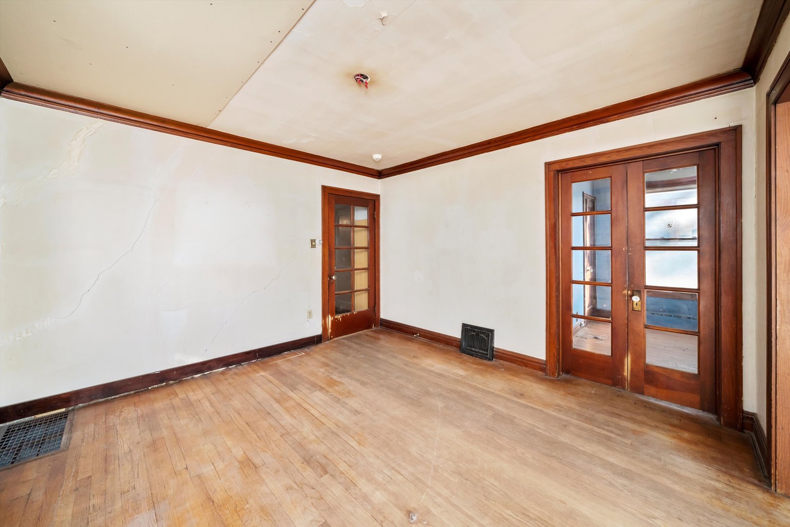 7424 57th Place Summit, IL 60501 - Photo 5 of 13 a view of an empty room with a window and wooden floor