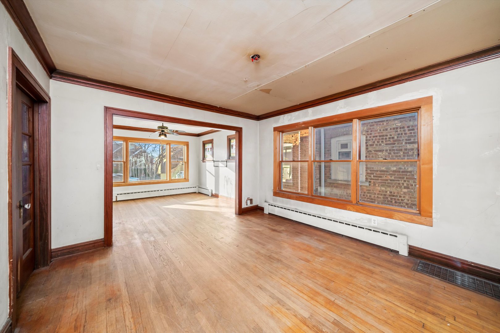 7424 57th Place Summit, IL 60501 - Photo 6 of 13 a view of an empty room with wooden floor and a window