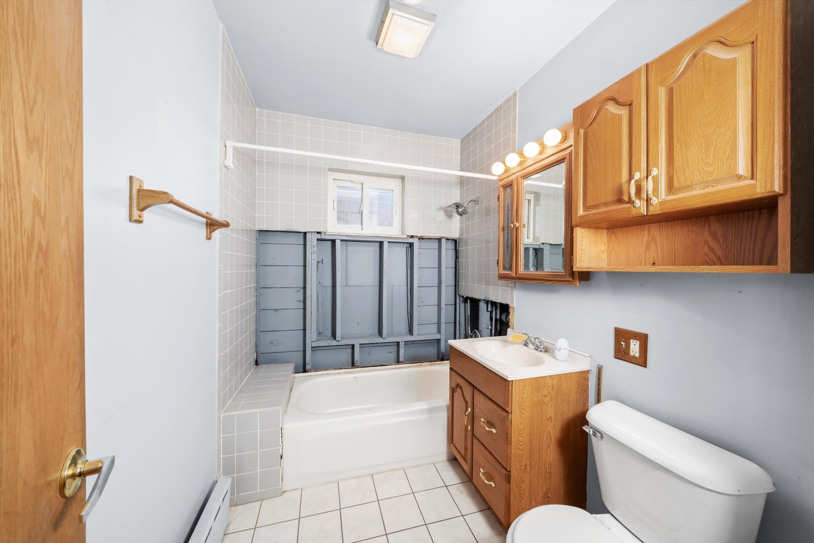 7424 57th Place Summit, IL 60501 - Photo 7 of 13 a bathroom with a sink toilet vanity and bathtub