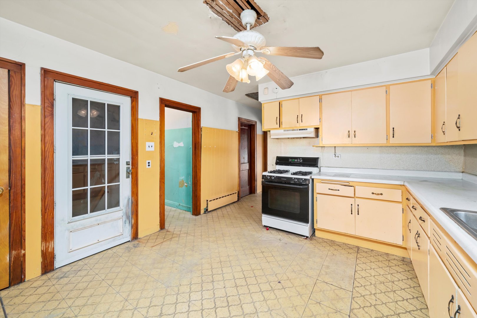 7424 57th Place Summit, IL 60501 - Photo 9 of 13 a kitchen with granite countertop a stove a sink and a refrigerator