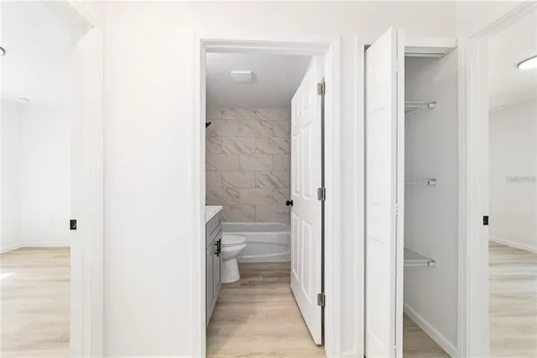 a bathroom with a granite countertop toilet a sink and a mirror