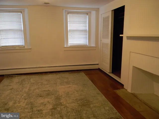 a view of a room with wooden floor and window