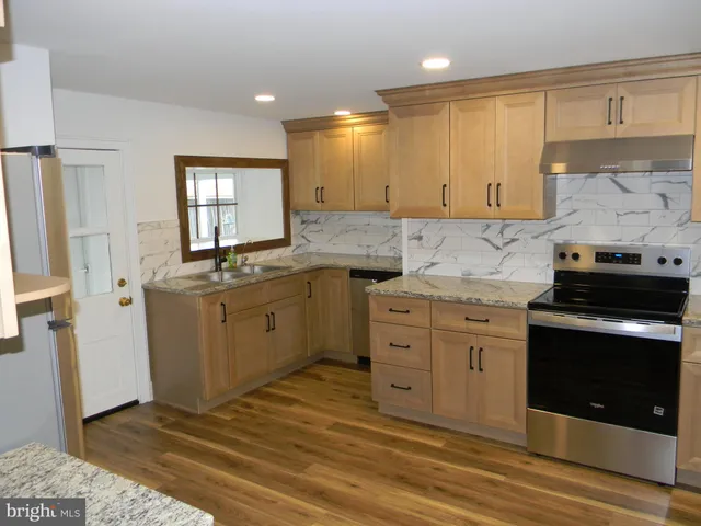 a kitchen with white cabinets and appliances