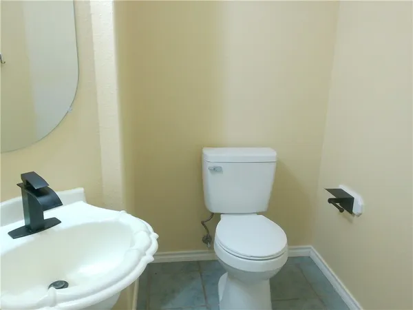a white toilet sitting next to a white sink