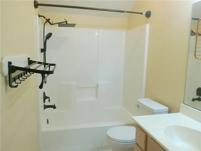 a bathroom with a shower a toilet and sink