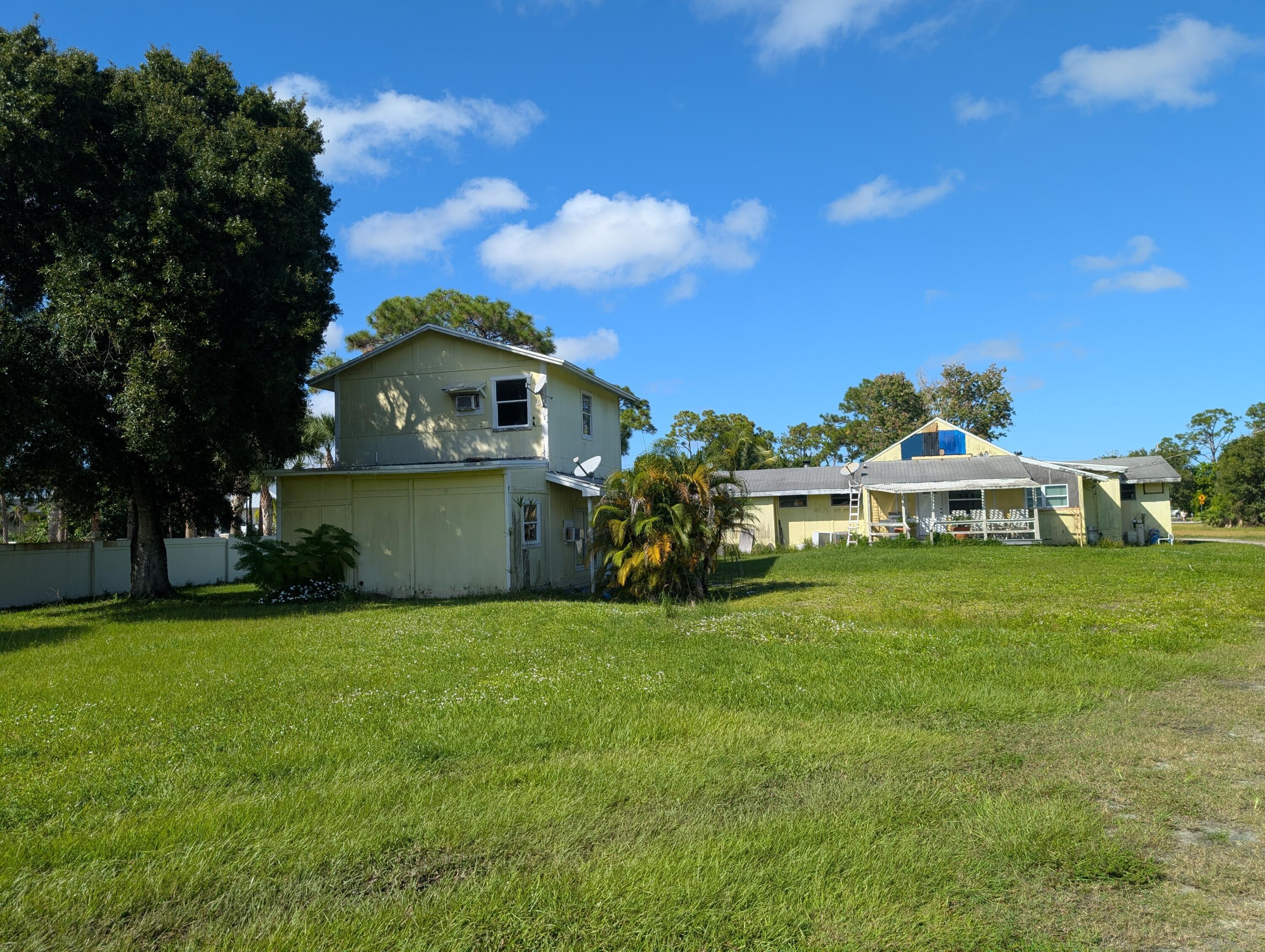 1500 Southeast Cove Road Stuart, FL 34997 - Photo 17 of 24 a front view of a house with a garden