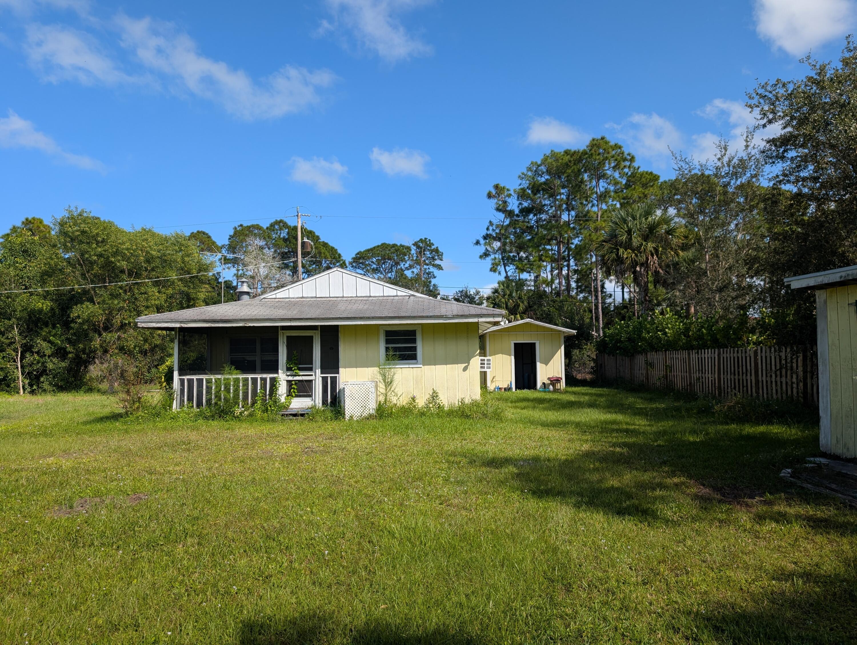1500 Southeast Cove Road Stuart, FL 34997 - Photo 19 of 24 a front view of a house with a yard