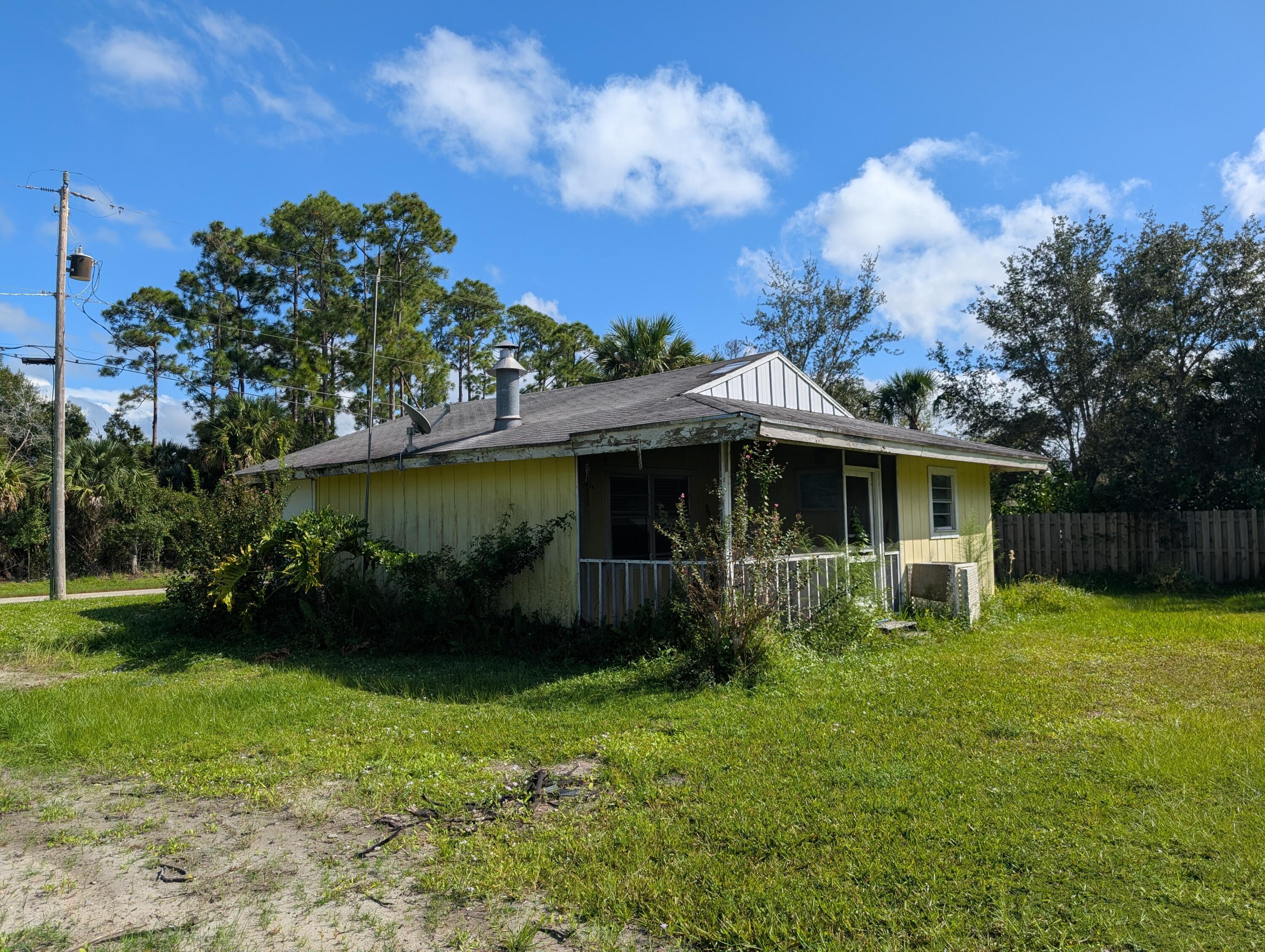 1500 Southeast Cove Road Stuart, FL 34997 - Photo 21 of 24 a view of a house with a yard