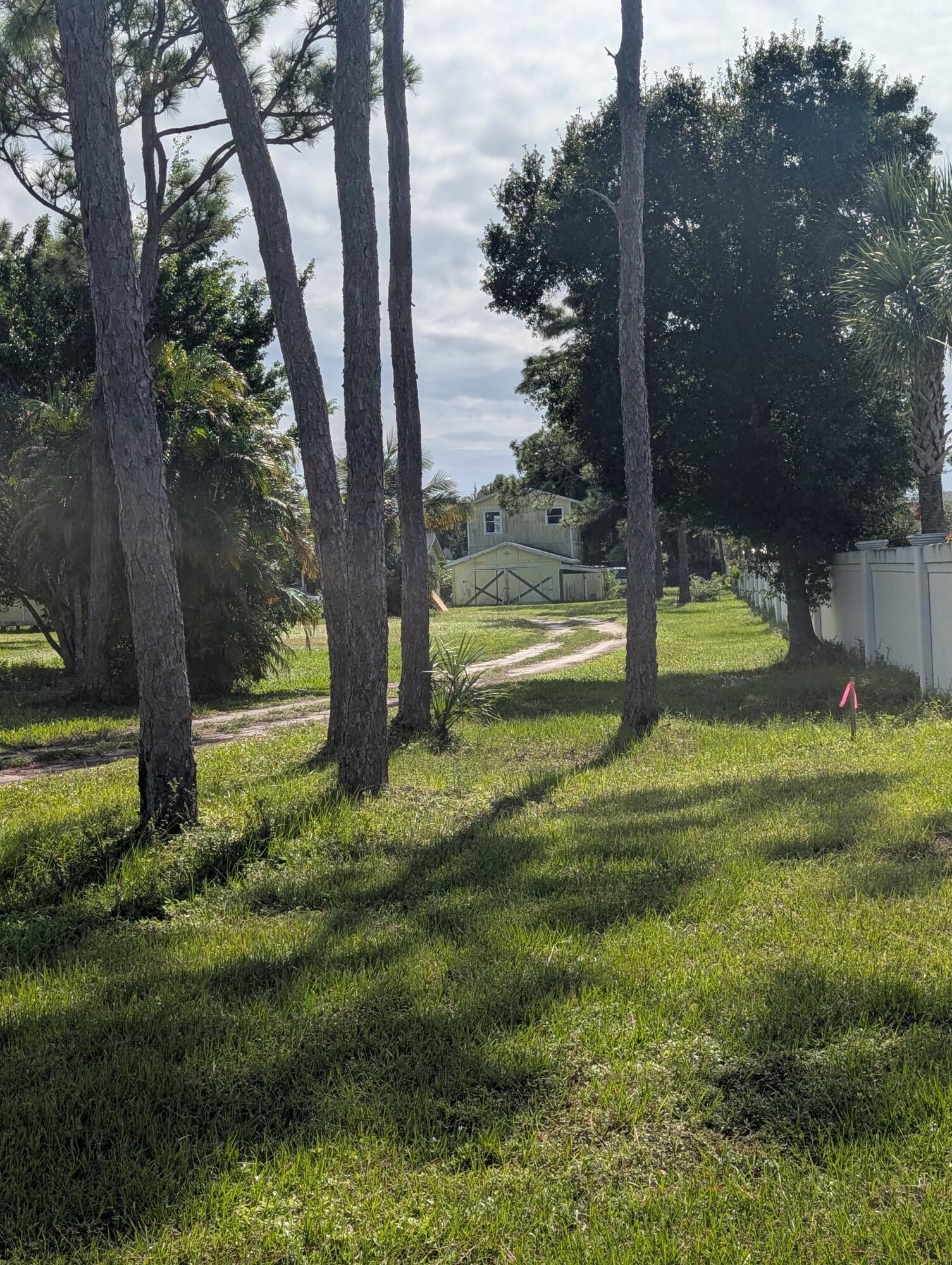1500 Southeast Cove Road Stuart, FL 34997 - Photo 24 of 24 a view of outdoor space with a garden and trees