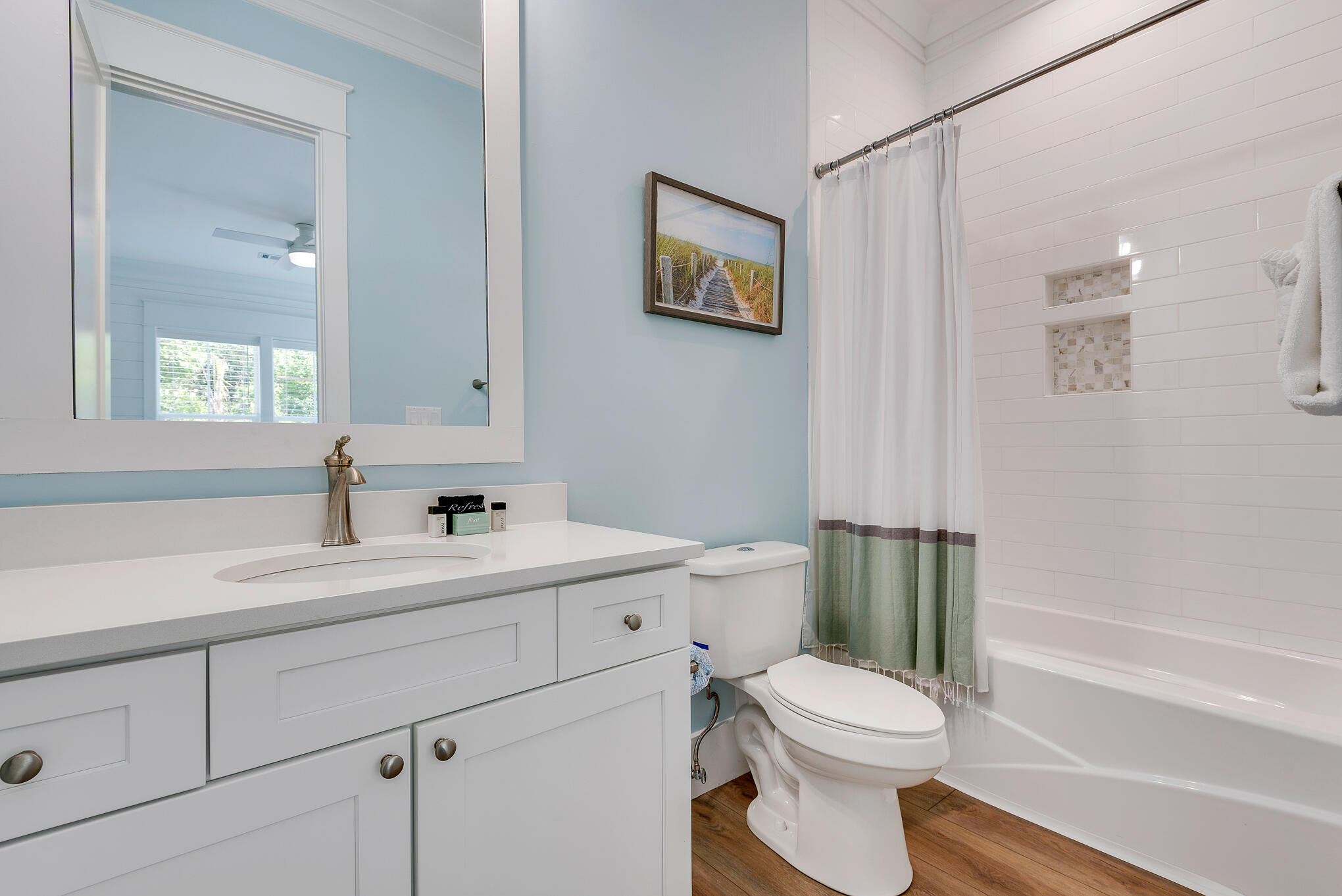 8427 East County Highway Seacrest, FL 32461 - Photo 16 of 74 a bathroom with a sink a toilet and a mirror