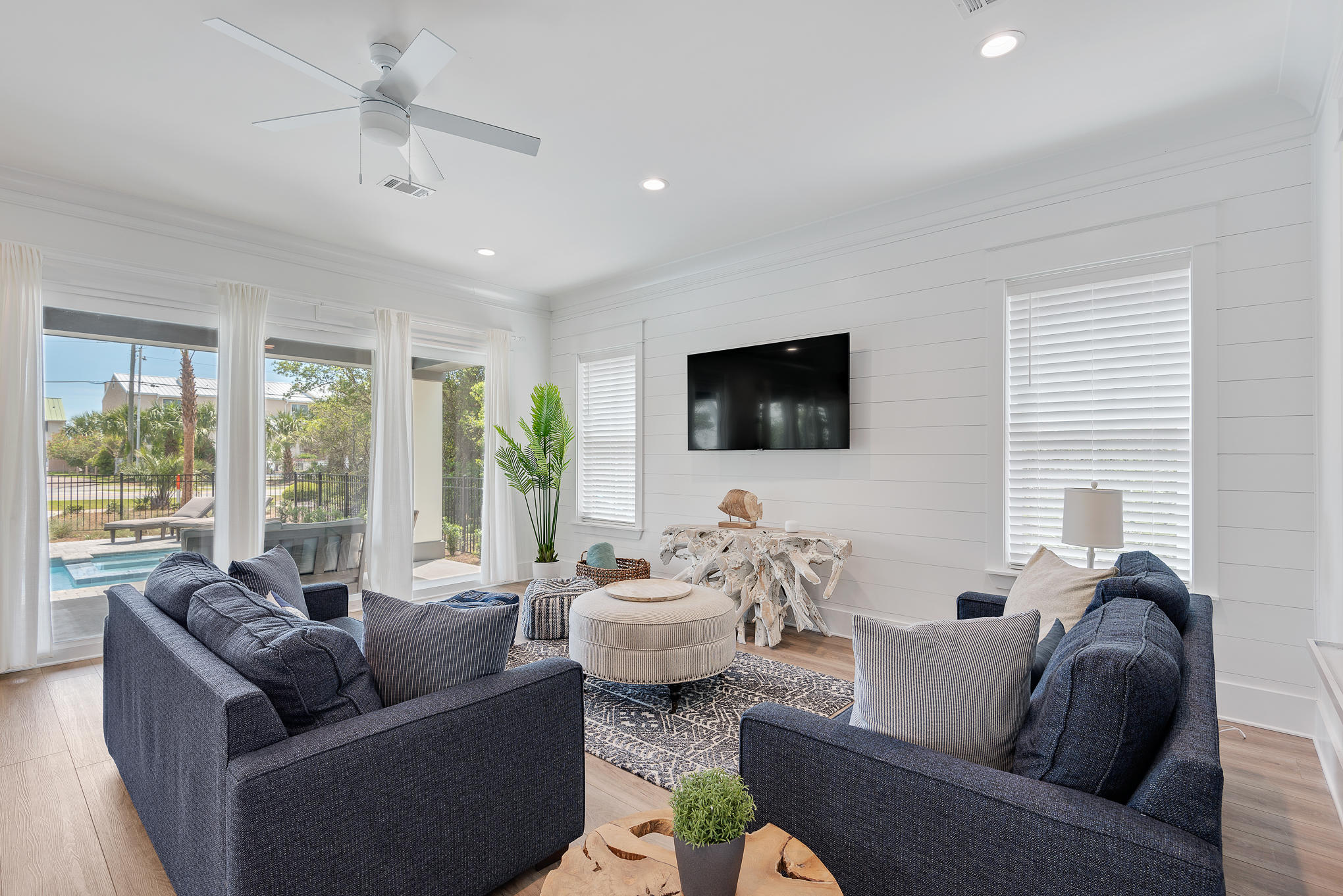 8427 East County Highway Seacrest, FL 32461 - Photo 24 of 74 a living room with furniture flat screen tv and a large window