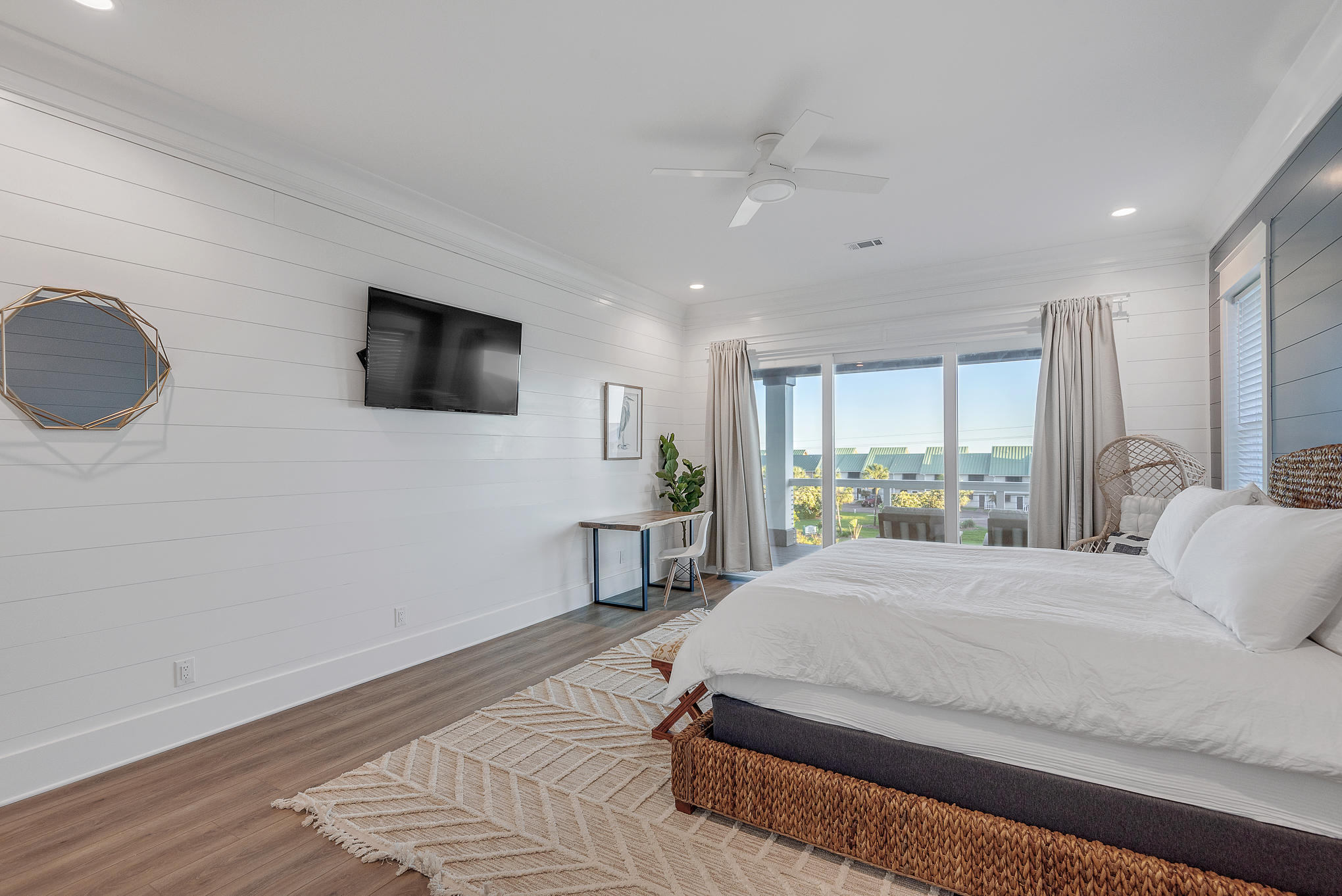 8427 East County Highway Seacrest, FL 32461 - Photo 57 of 74 a bedroom with a bed a window and a flat screen tv