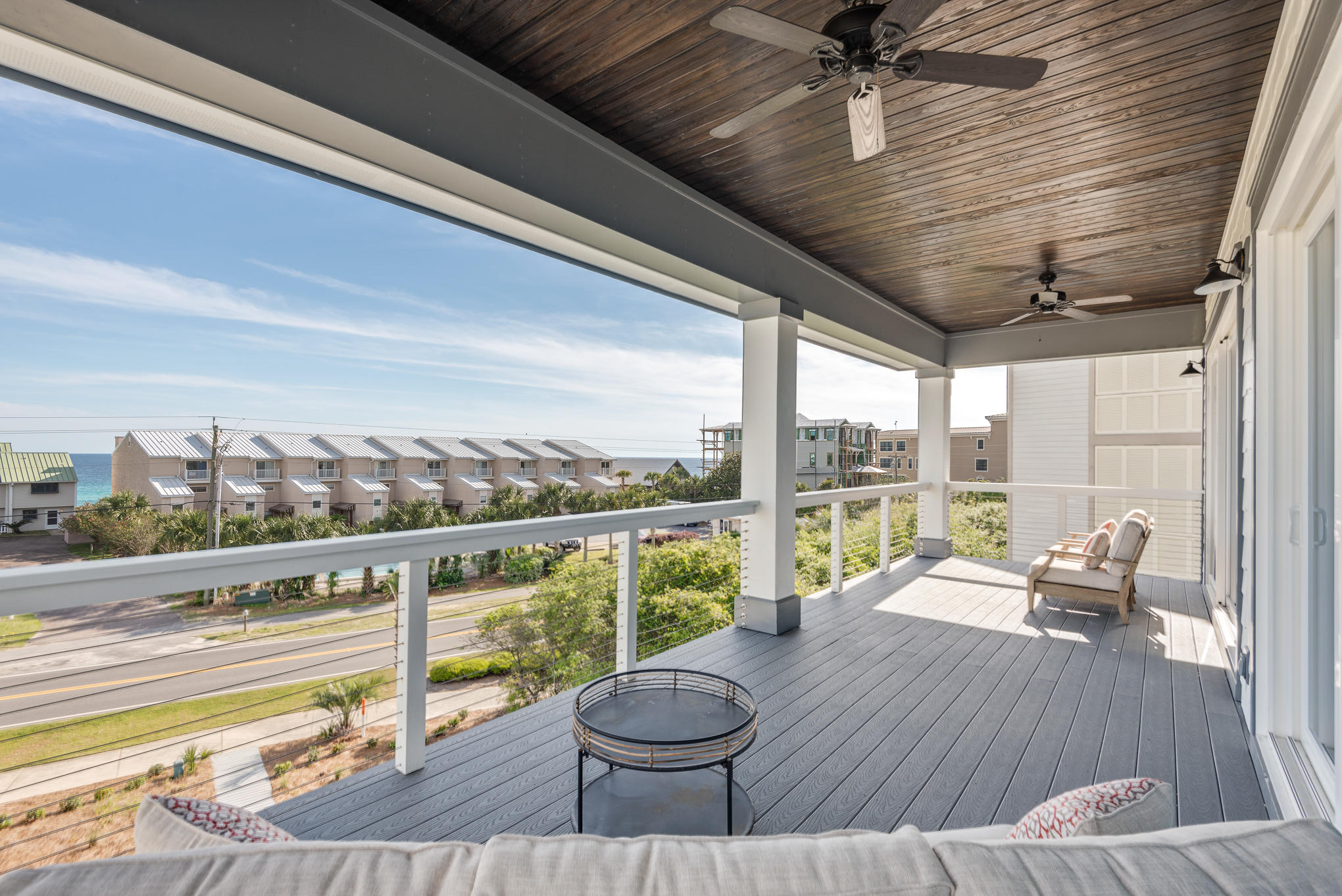 8427 East County Highway Seacrest, FL 32461 - Photo 63 of 74 a view of a balcony with couch and wooden floor