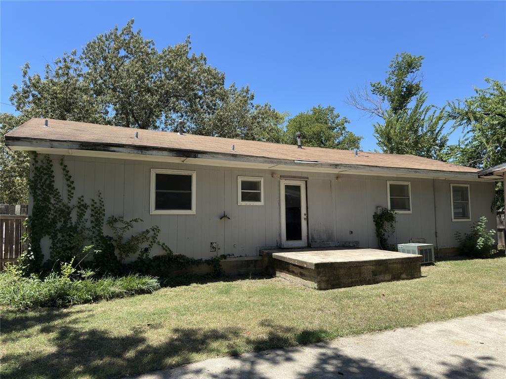 611 South Ruddell Street Denton, TX 76205 - Photo 15 of 18 a front view of house with yard and trees in the background