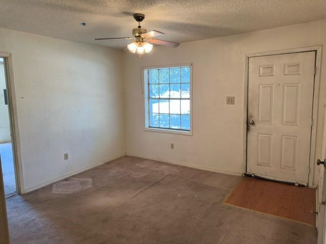 611 South Ruddell Street Denton, TX 76205 - Photo 2 of 18 an empty room with windows and fan