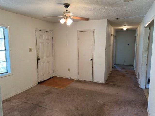 611 South Ruddell Street Denton, TX 76205 - Photo 3 of 18 an empty room with windows and fan