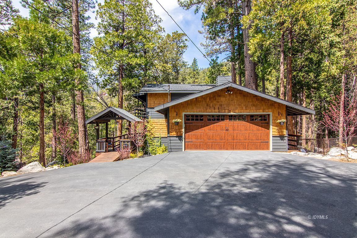 24750 Upper Rim Rock Road Idyllwild, CA 92549 - Photo 1 of 58 a front view of a house with a yard and garage