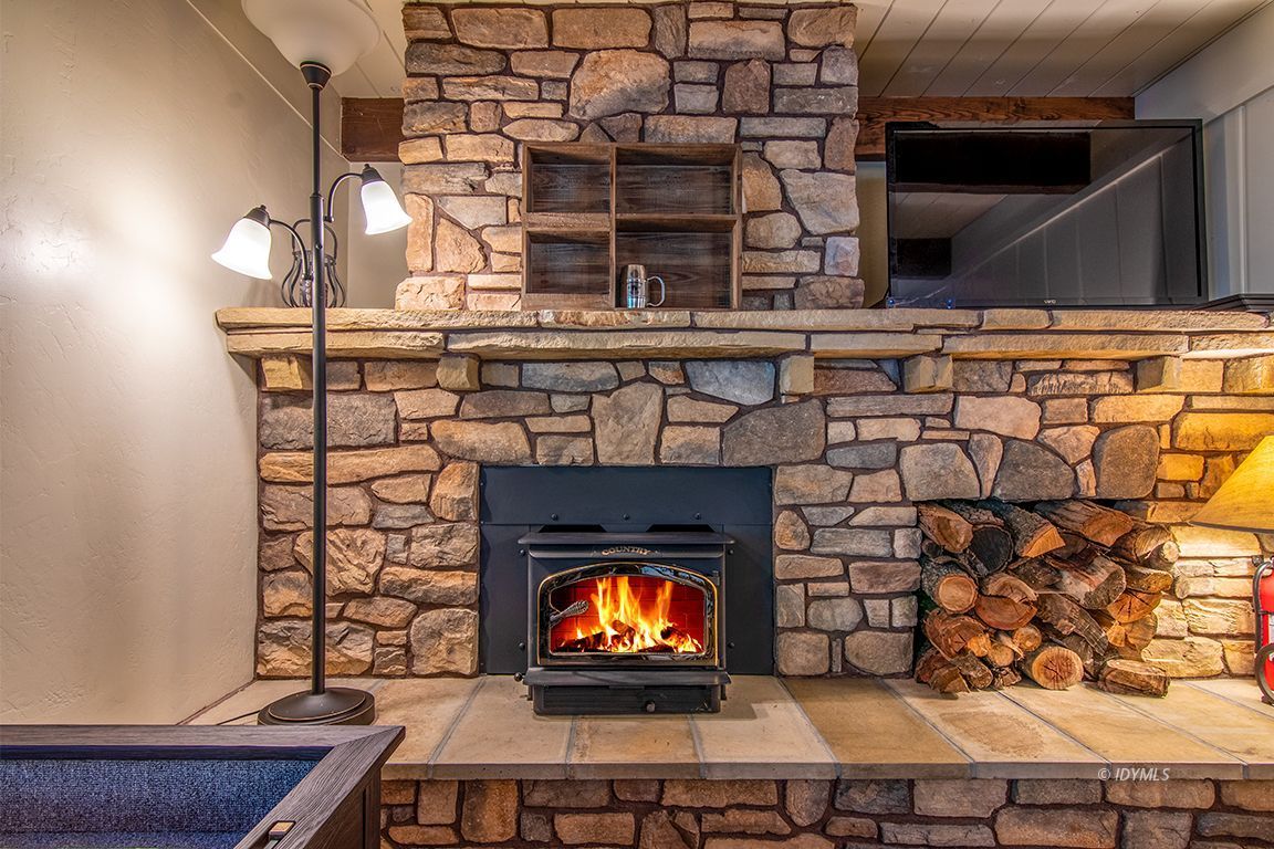 24750 Upper Rim Rock Road Idyllwild, CA 92549 - Photo 23 of 58 a fireplace with wooden floor