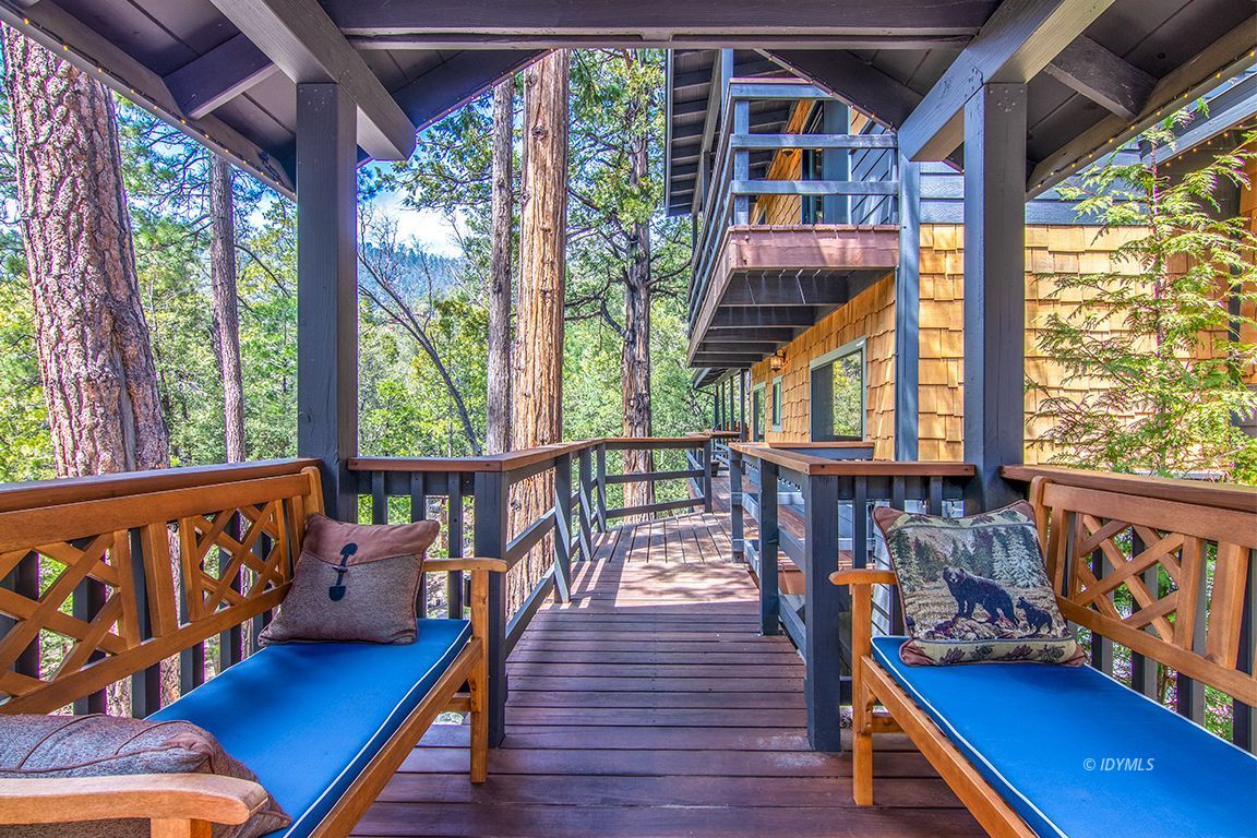 24750 Upper Rim Rock Road Idyllwild, CA 92549 - Photo 4 of 58 a balcony with wooden floor and outdoor seating