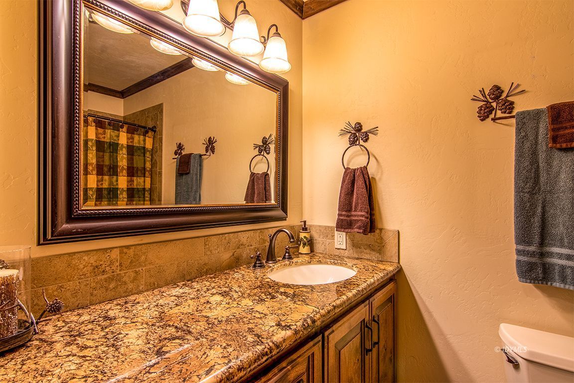24750 Upper Rim Rock Road Idyllwild, CA 92549 - Photo 31 of 58 a bathroom with a granite countertop sink and a mirror